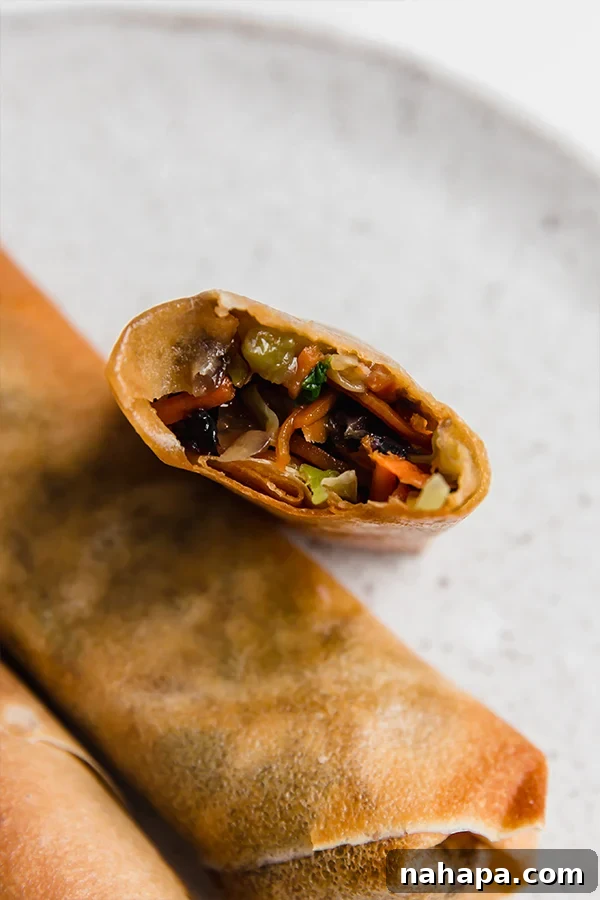 Air fryer egg rolls open with filling showing