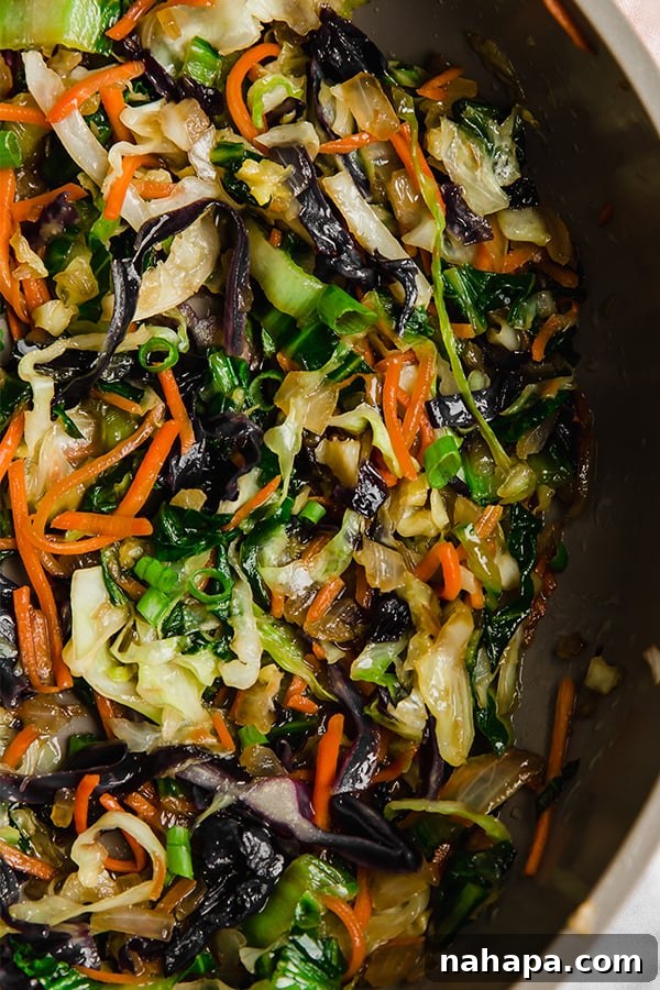 Air fryer egg roll filling cooking in skillet