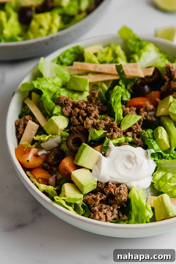 Primal Taco Bowl 3 Close-up of paleo taco salad in a bowl, showcasing fresh ingredients and seasoned beef