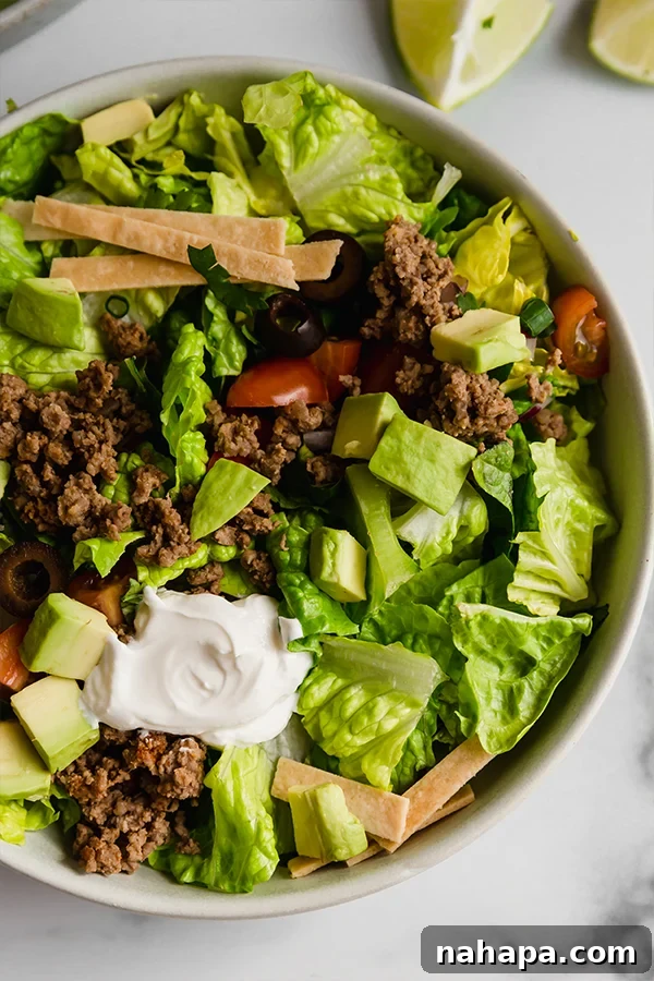 Primal Taco Bowl 5 A large bowl of paleo taco salad with a serving spoon, ready for sharing