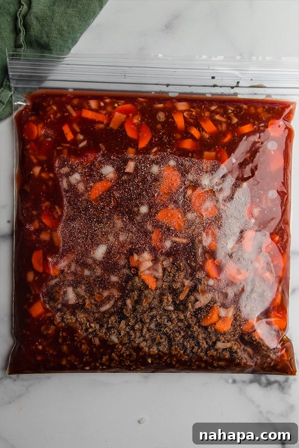 A batch of Asian Inspired Chili neatly packed in a freezer-safe bag, demonstrating its convenience as a make-ahead meal.