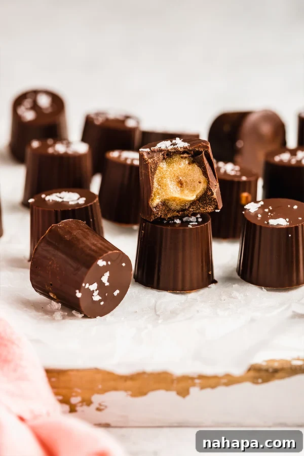 Delicious Salted Caramel Cups, stacked and ready to eat, showing the rich chocolate and gooey caramel layers.
