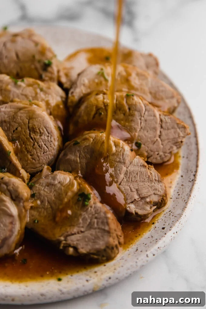 instant pot pork tenderloin on plate, sliced with toothpicks