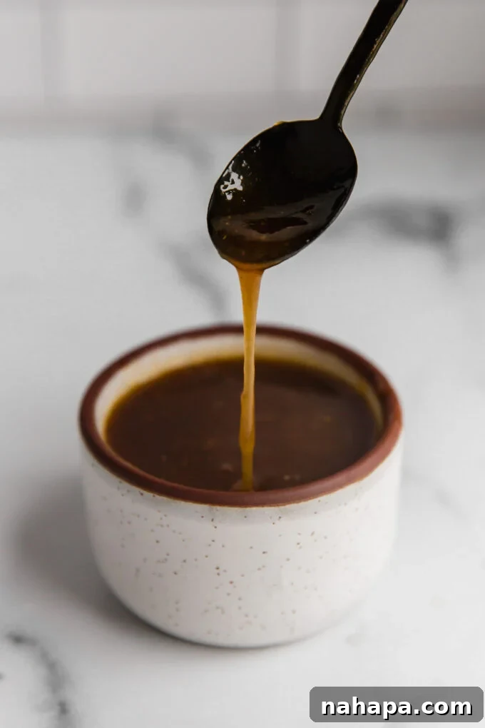 pork tenderloin gravy in cup with spoon