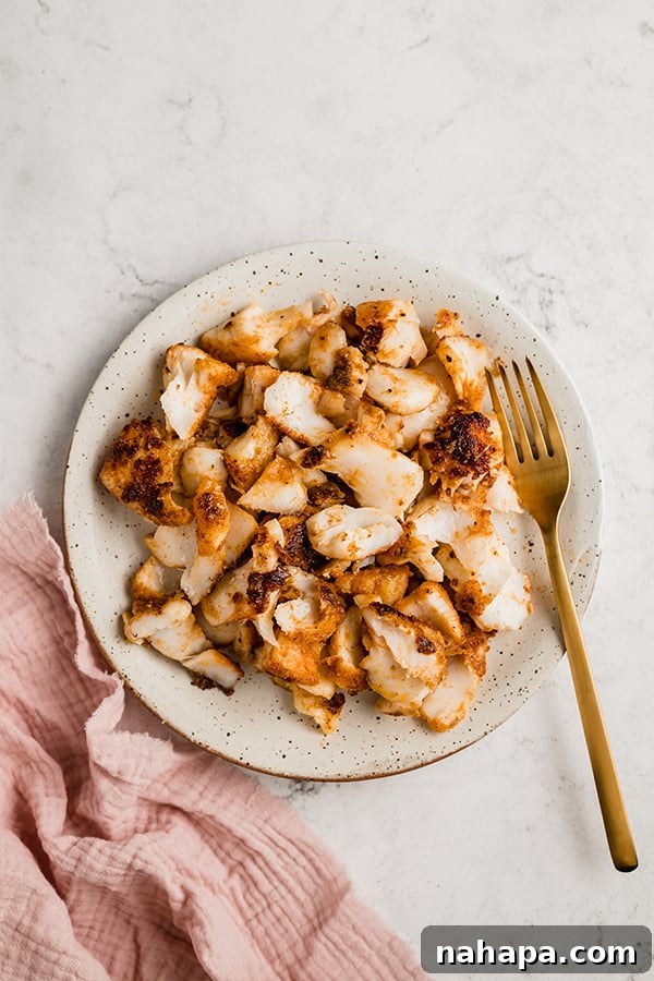 Effortless Fish Tacos with Zesty Slaw 4 Seasoned white fish fillets cooking in a large pan with avocado oil.