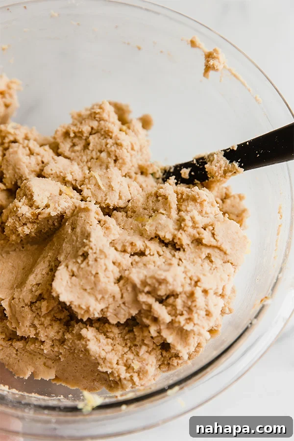 Coconut Flour Lemon Banana Cake batter in a mixing bowl, showcasing the thick, dough-like consistency before baking