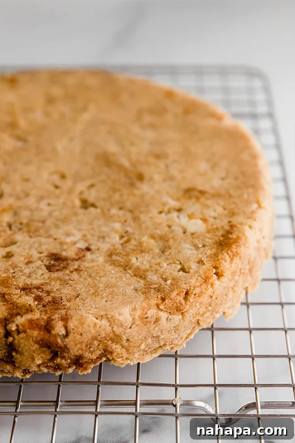 Freshly baked Paleo Vegan Coconut Flour Lemon Banana Cake cooling on a wire rack to achieve perfect texture