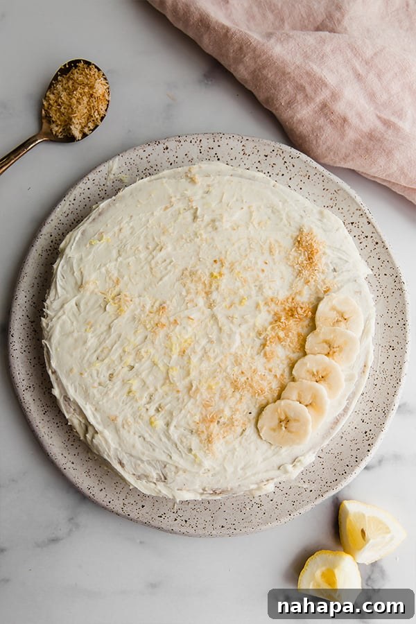 Beautifully decorated Paleo Vegan Coconut Flour Lemon Banana Cake, ready to be served at a celebration