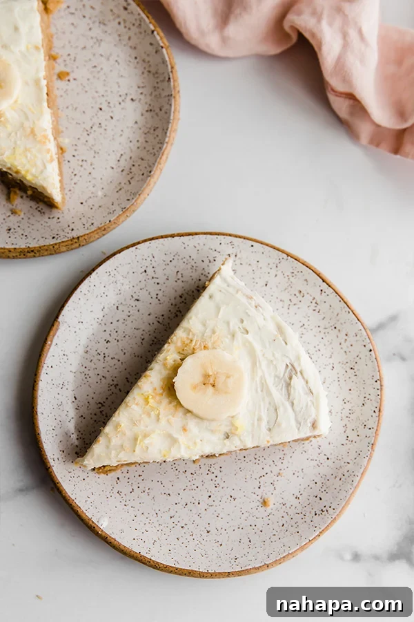 Full Paleo Vegan Coconut Flour Lemon Banana Cake on a wooden board with a slice cut out, ready to be served