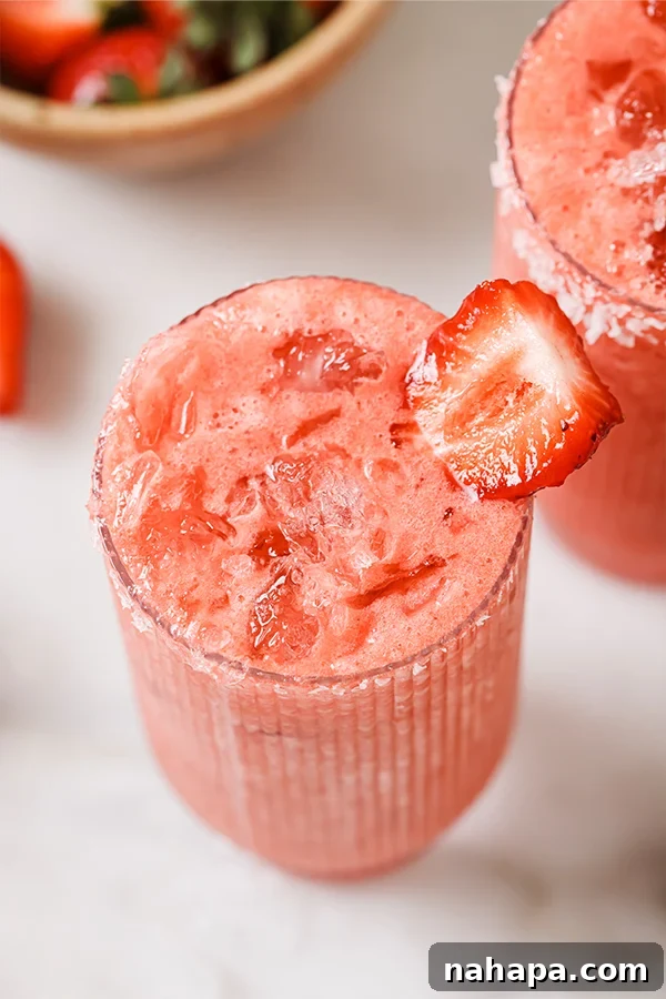 Refreshing Strawberry Margarita Mocktail served in a glass with a salted rim and lime garnish.