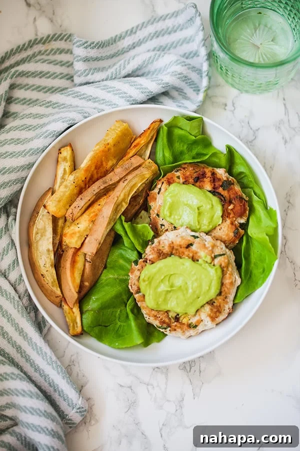 Beginner's 7-Day AIP Jumpstart 4 Spinach Avocado Chicken Burgers served on a plate