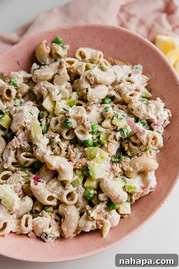 Vibrant gluten-free tuna pasta salad, featuring grain-free pasta, fresh tuna, and colorful vegetables, garnished with fresh dill.