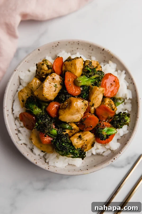 Honey Garlic Chicken Stir Fry in a serving bowl with chopsticks
