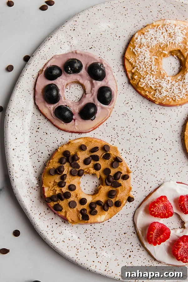 Up close image showcasing beautifully decorated apple 'donuts' arranged on a serving plate