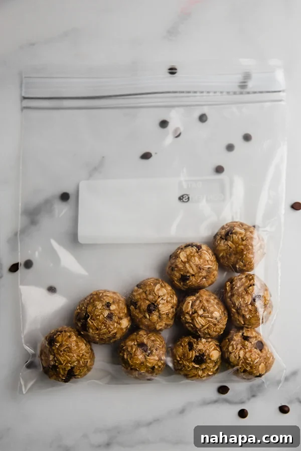 Freshly rolled energy bites placed in a plastic bag, ready to be stored in the fridge or freezer for later enjoyment.