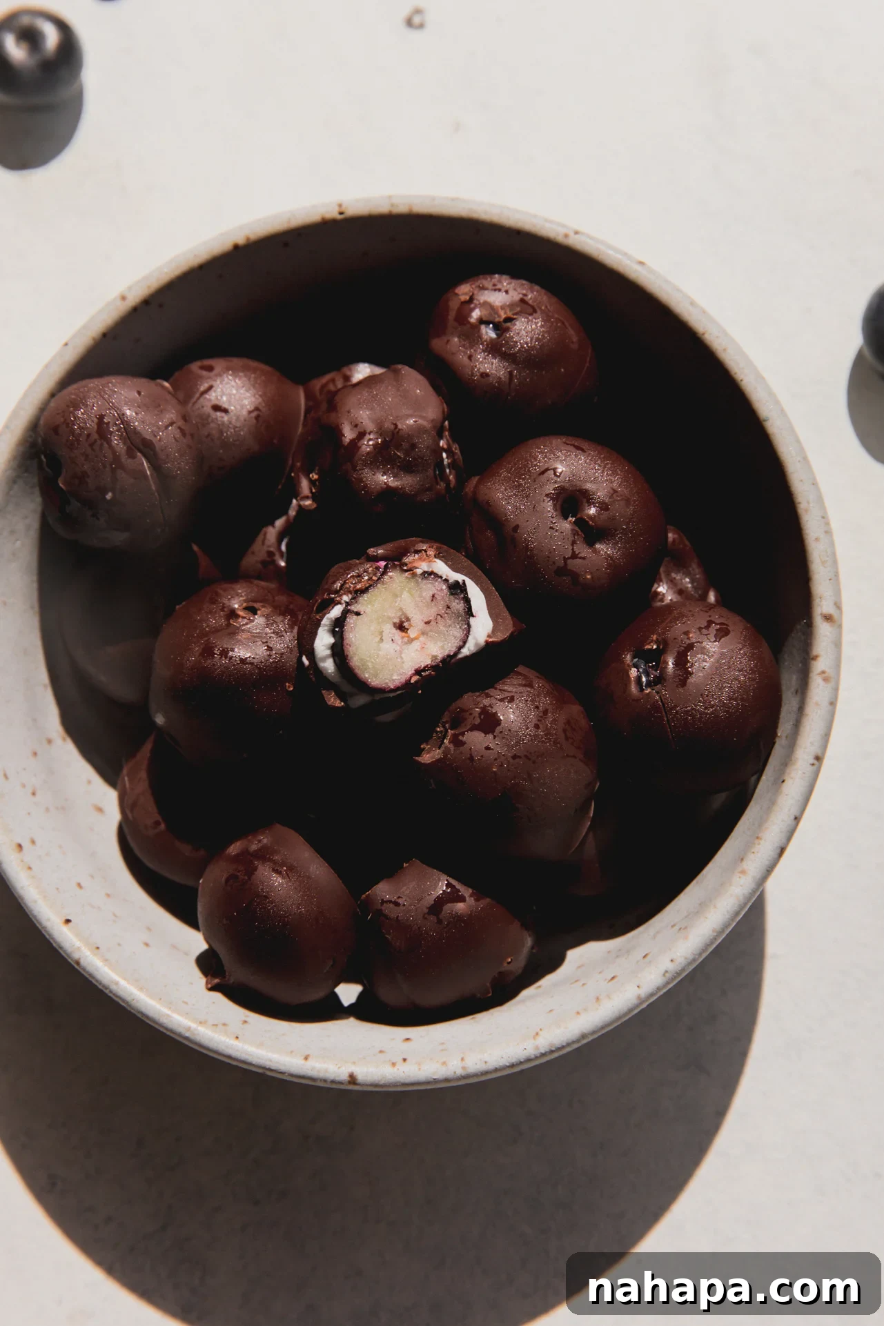 Chocolate blueberries in a bowl.