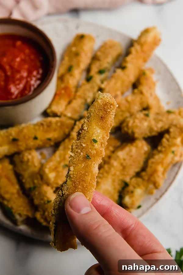 A single pork panko zucchini fry, showing the crispy coating