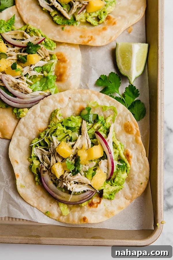Tropical Paleo AIP Mango Chicken Tostadas 2 Delicious Mango Chicken Tostadas assembled and ready to eat on a serving tray