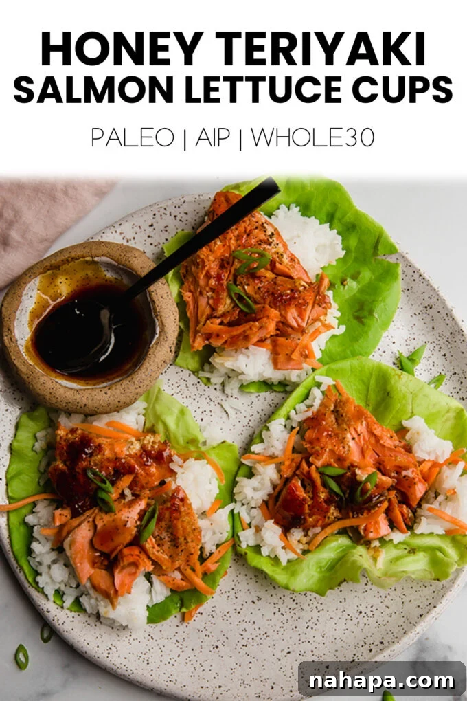 A beautifully composed overhead shot of four honey teriyaki salmon lettuce cups on a light-colored plate, emphasizing the fresh ingredients and appetizing presentation, ready to be enjoyed.