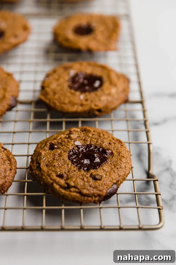 Soft and Chewy Paleo Vegan Almond Butter Cookies 3 Up close image of freshly baked Flourless Almond Butter Cookies cooling on a wire rack.
