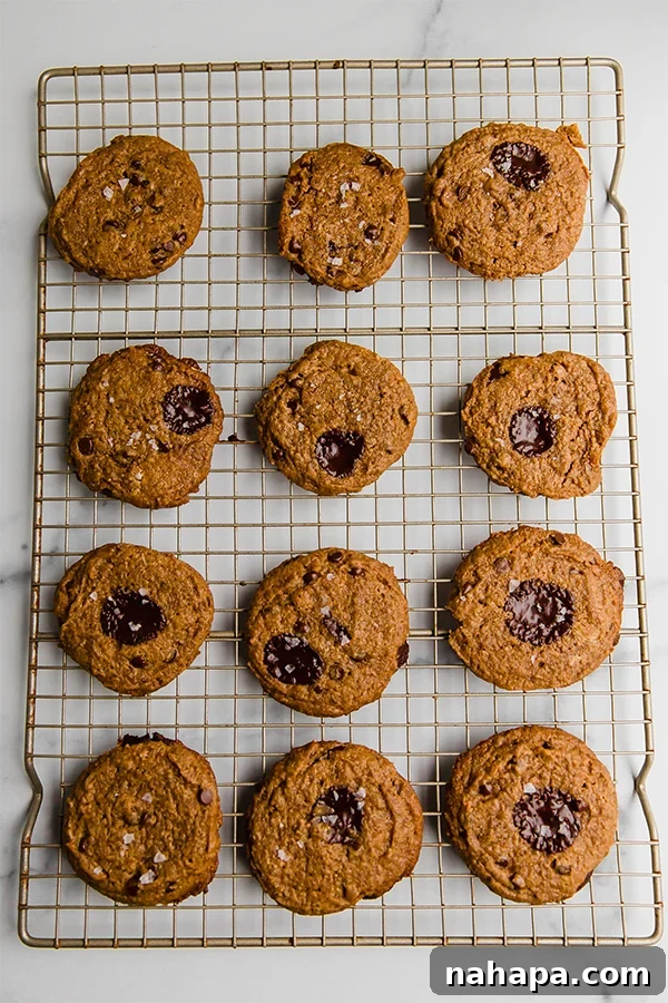 Soft and Chewy Paleo Vegan Almond Butter Cookies 4 Top view of freshly baked Flourless Almond Butter Cookies cooling on a wire rack, sprinkled with flakey salt.