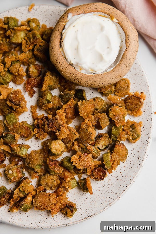 Crispy Oven-Baked Okra: Gluten-Free, Keto, Paleo, AIP-Friendly 2 Crispy oven fried okra served on a plate with a side of creamy dipping sauce