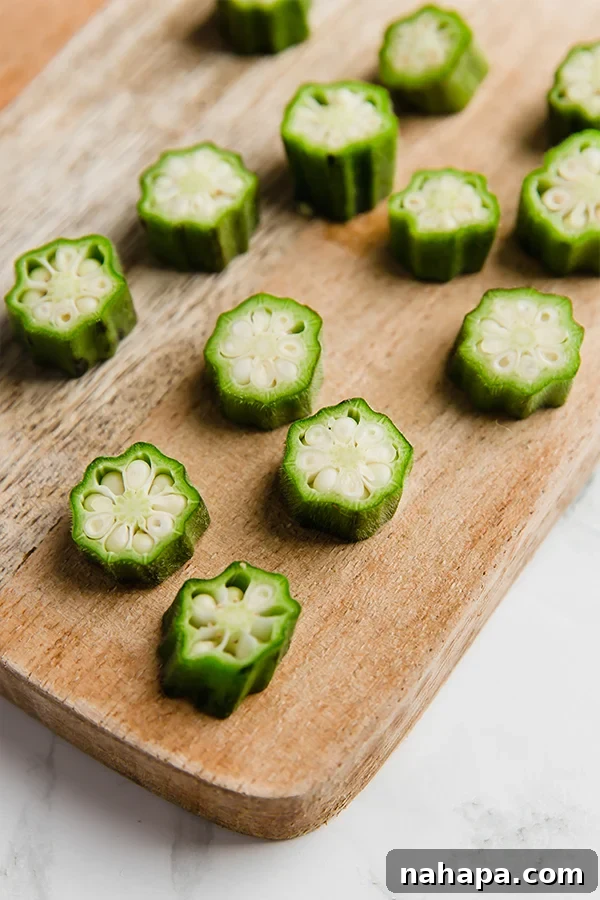Crispy Oven-Baked Okra: Gluten-Free, Keto, Paleo, AIP-Friendly 3 Chopped okra pieces on a cutting board, ready for coating