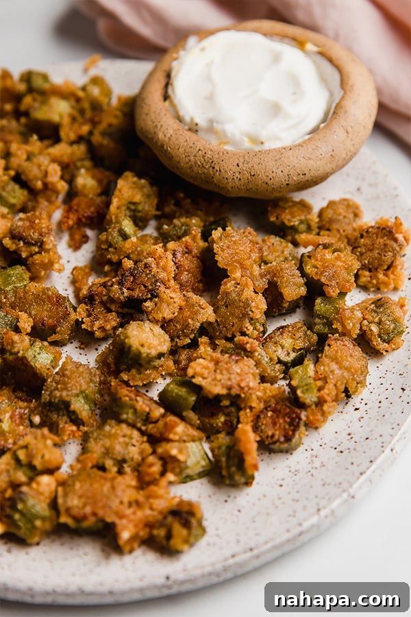 Crispy Oven-Baked Okra: Gluten-Free, Keto, Paleo, AIP-Friendly 5 Crispy oven fried okra on a plate with a bowl of dipping sauce