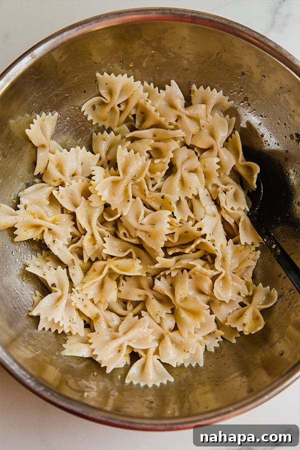 Seasoned pasta ready to be spread on a baking sheet for oven baking