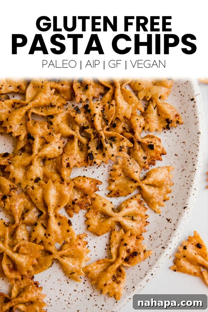 A top-down view of a bowl of pasta chips with various dipping sauces