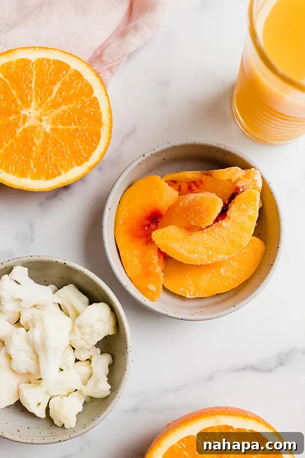 Healthy Banana-Free Orange Creamsicle Smoothie 3 Smoothie ingredients separated in small bowls on counter