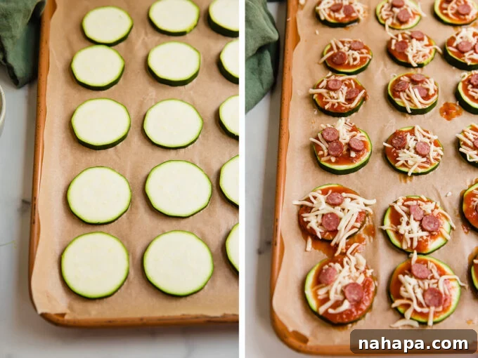 Sliced zucchini rounds arranged on a baking sheet, topped with marinara sauce, cheese, and thinly sliced beef (Chomps stick) before baking.