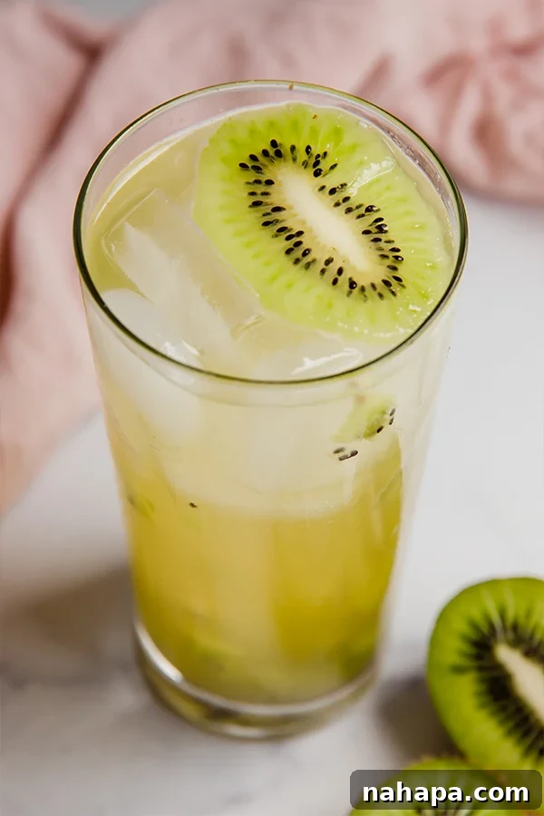 Two glasses of Kiwi Refresher with ice and fresh kiwi slices, ready to be served