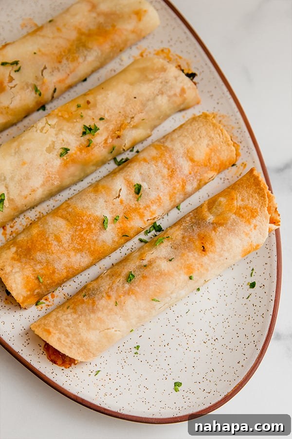 Wholesome Pizza Roll-Ups: Gluten-Free, Paleo, and AIP Friendly 4 Cooked gluten-free pizza roll ups served on a platter with fresh herbs