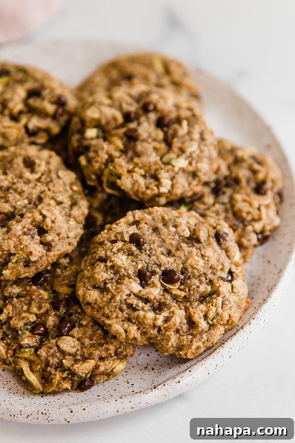 Oatmeal zucchini cookies stacked on a plate, showcasing their soft, chewy texture