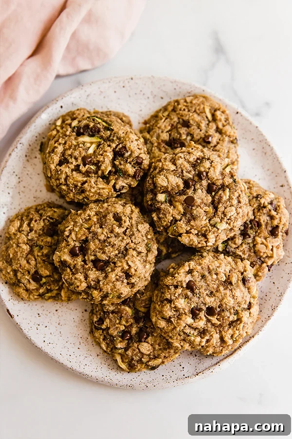 Top view of Oatmeal zucchini cookies stacked on a plate, highlighting their appealing golden-brown finish
