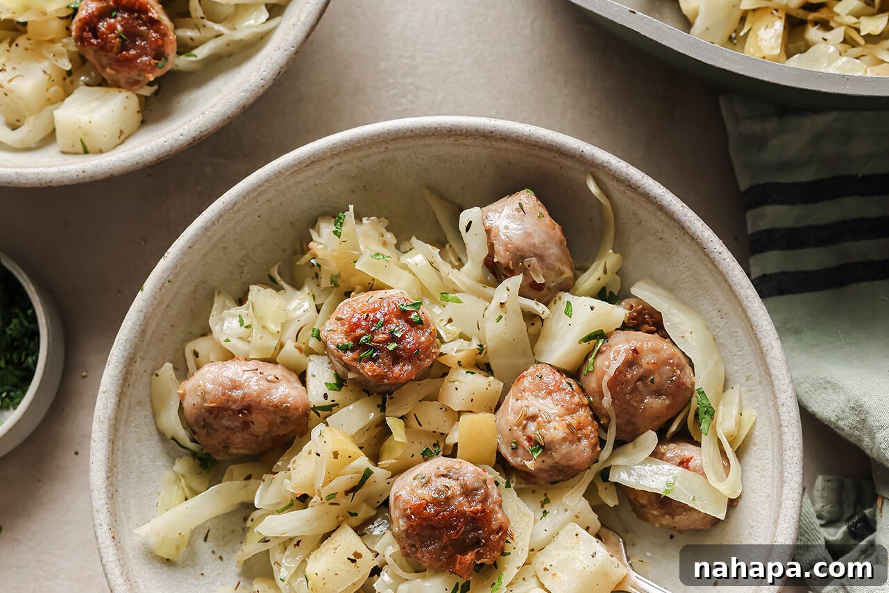 A serving of the completed cabbage and sausage breakfast skillet garnished with fresh parsley in a rustic bowl.