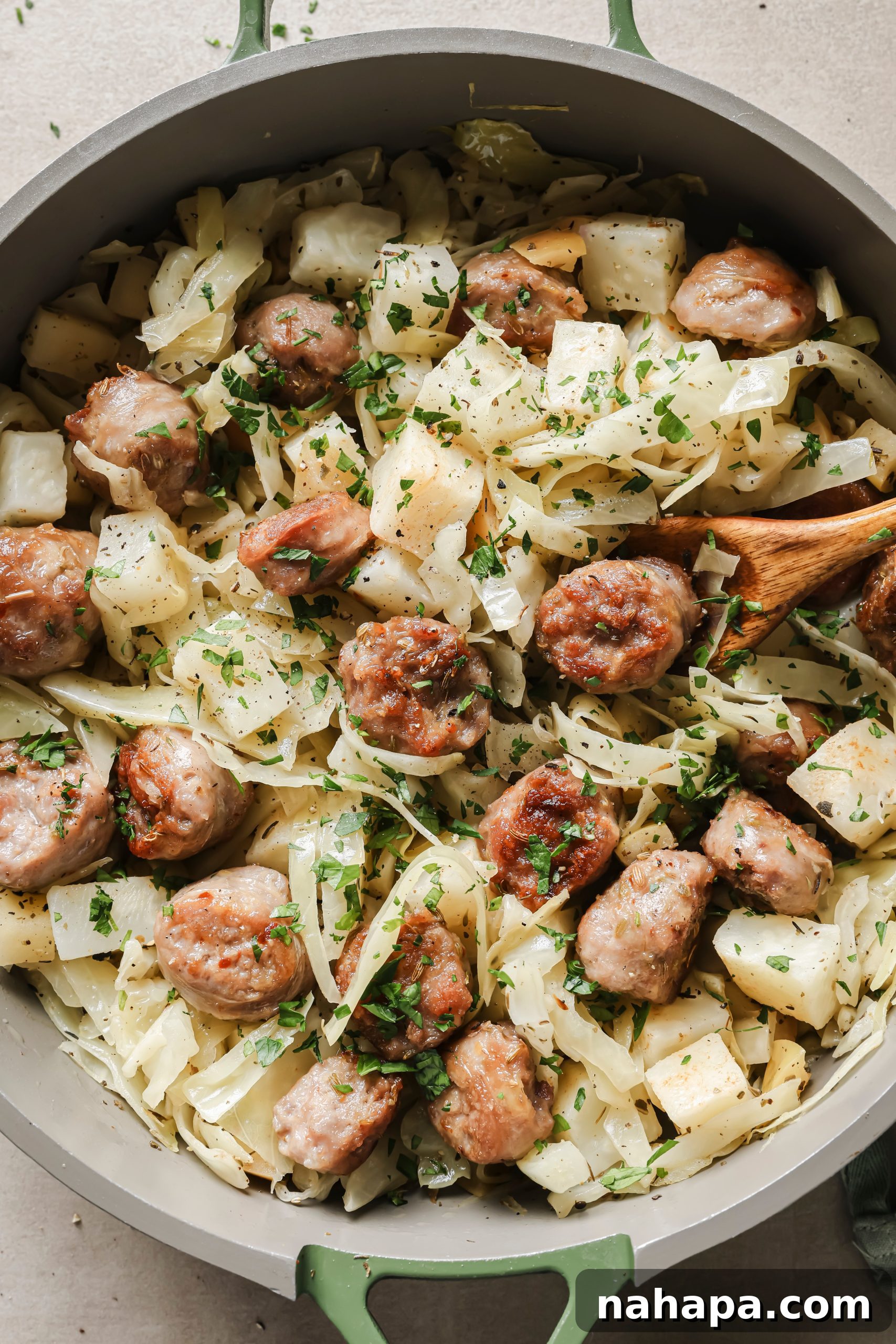 Finished Cabbage and Sausage Skillet served in a bowl, garnished with fresh parsley.