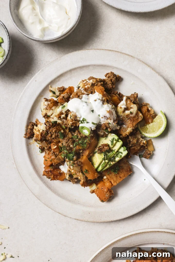 Ground beef enchilada skillet on a plate with a fork.