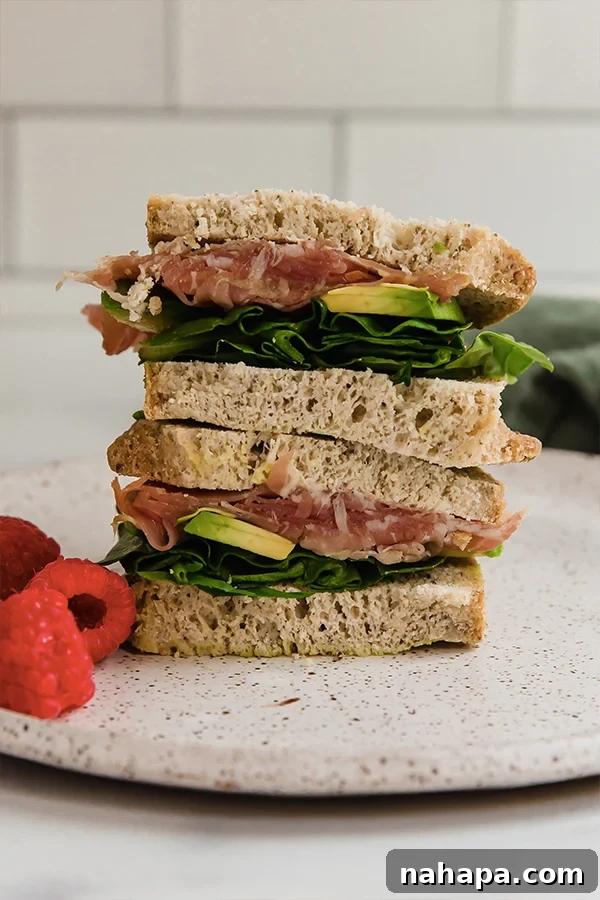 10 Easy Gluten-Free Lunches for Busy People 12 A gourmet gluten-free sandwich with prosciutto, arugula, and avocado, sliced and ready to eat.