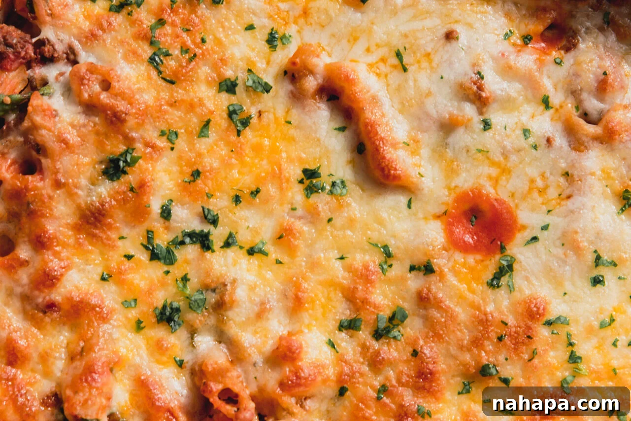 Finished no boil pasta bake, topped with melted cheese and fresh chopped parsley.
