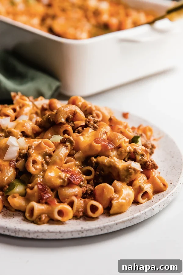 Ultimate No Boil Gluten Free Bacon Cheeseburger Pasta Bake 5 A full plate with a serving of bacon cheeseburger no boil pasta bake, showcasing its rich texture and toppings.