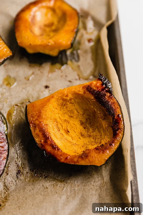 Roasted acorn squash halves, caramelized and tender, after baking in the oven.