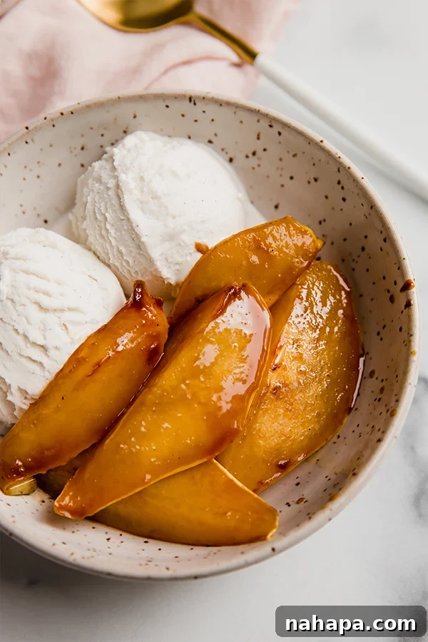 A bowl of freshly cooked caramelized pears, glistening with a sweet, spiced glaze, ready to be enjoyed.