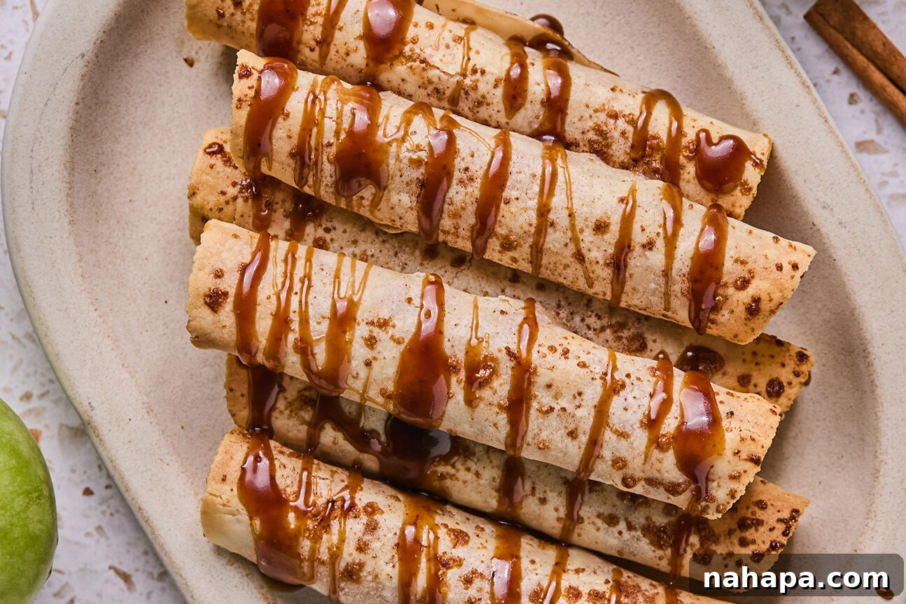 Apple Cinnamon Swirls Gluten Free 11 Apple pie roll ups on a platter drizzled with caramel.
