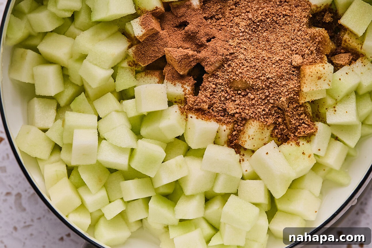 Apple Cinnamon Swirls Gluten Free 4 Chopped apple and coconut sugar, ready to be mixed and cooked in a pot.