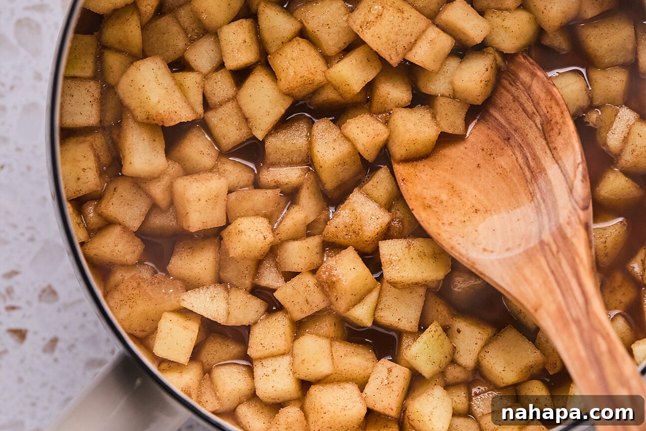 Apple Cinnamon Swirls Gluten Free 5 Chopped apple and coconut sugar stewed in a pot.