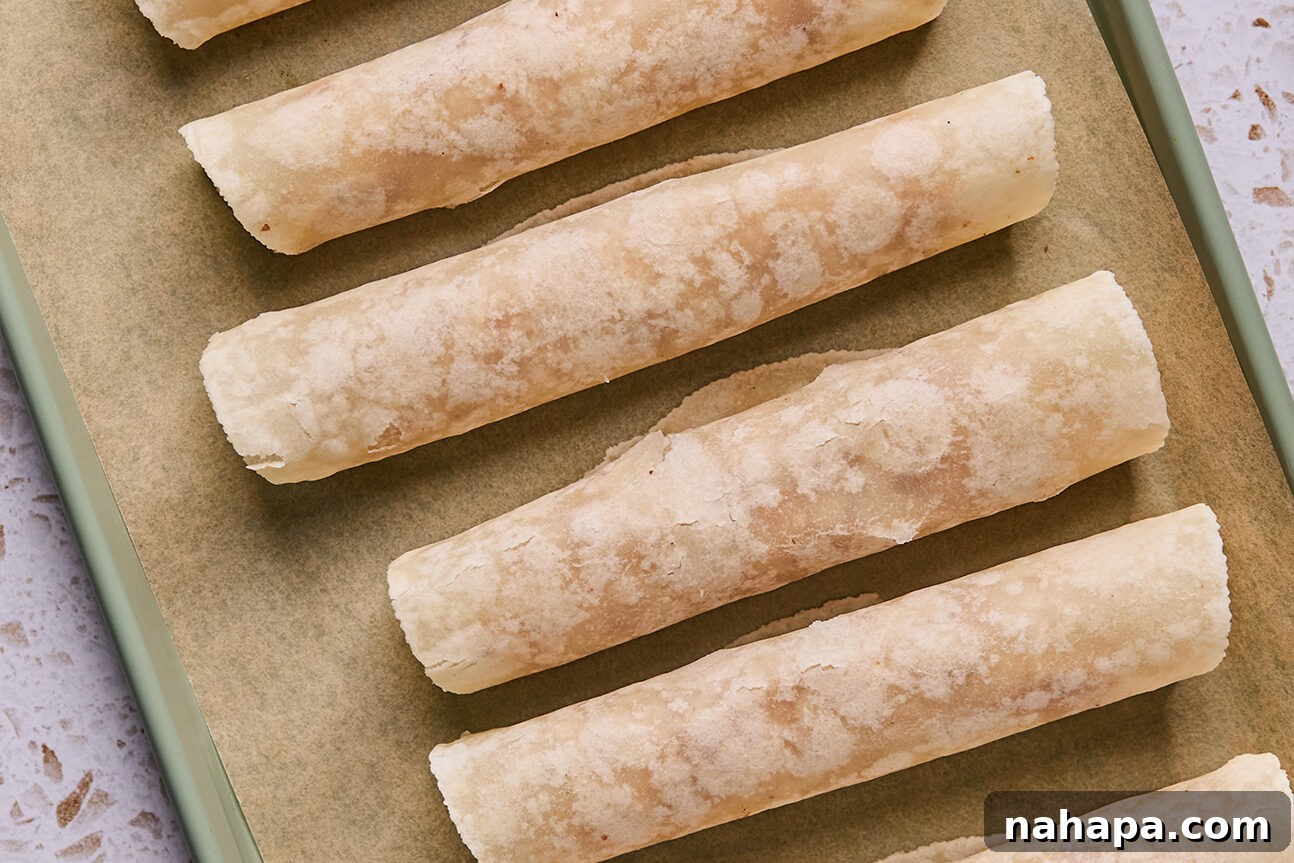 Apple Cinnamon Swirls Gluten Free 9 Apple pie roll ups rolled on a baking sheet.