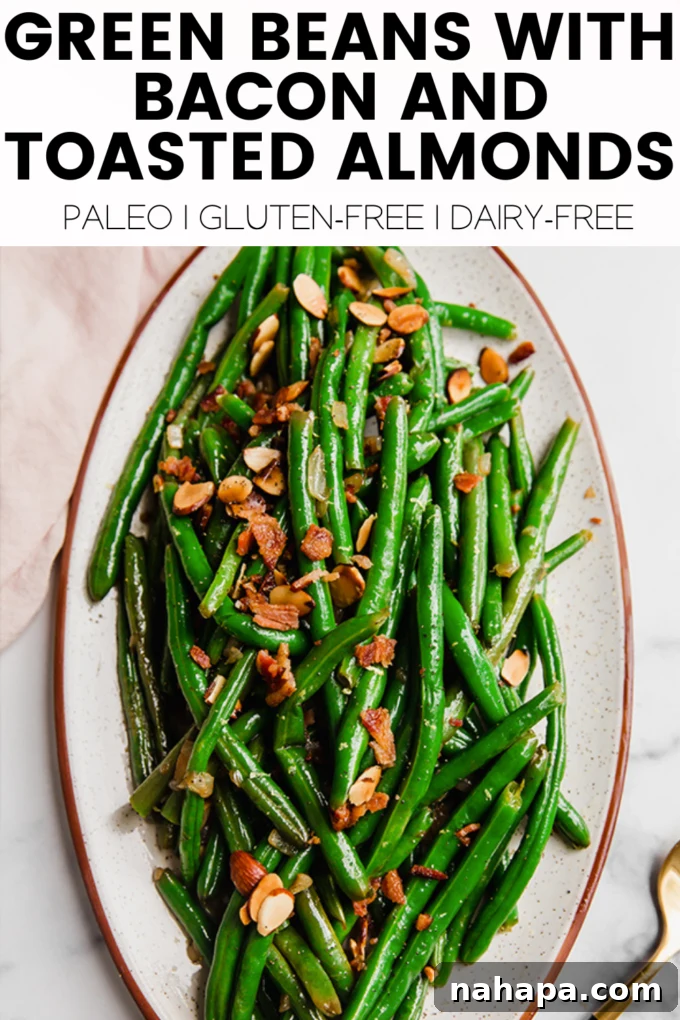 A high-angle shot showcasing a full platter of green beans, bacon, and toasted almonds, beautifully arranged.