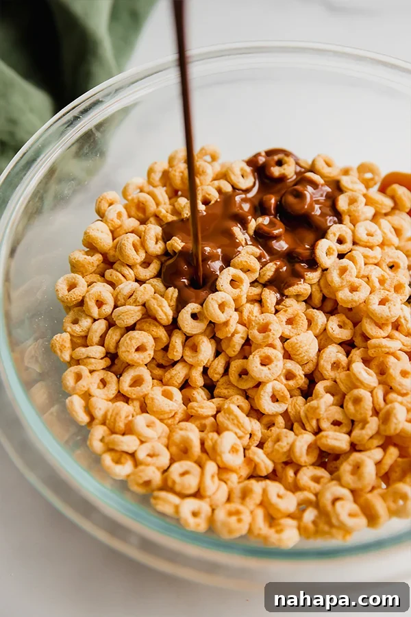 Mixing Lovebird cereal with chocolate coating in a large bowl